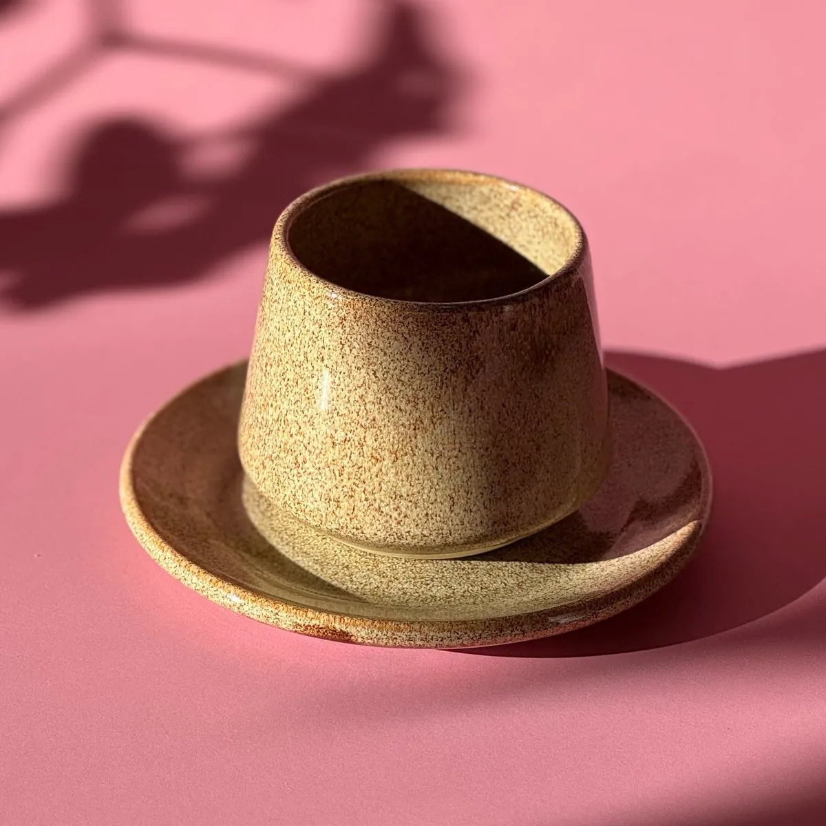 Speckled cup standing on its saucer